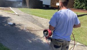 Plumber clearing a blocked household drain