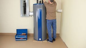 Person adjusting an electric hot water system